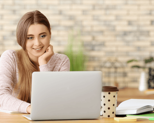 A person studying for the Praxis 5442 exam on a laptop