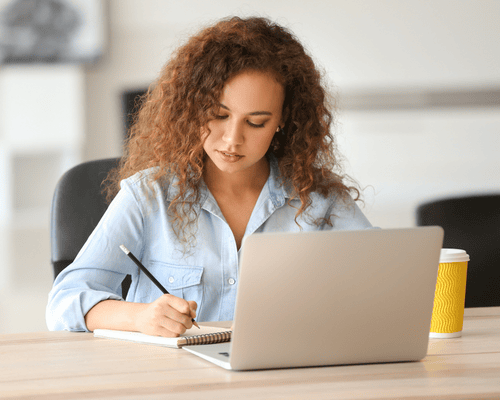 A person studying for the Praxis 5622 exam on a laptop