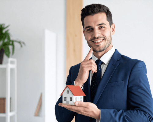 A real estate slaesperson with a house model